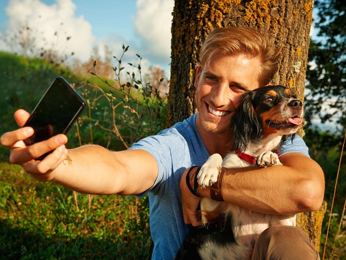 Friend taking selfie with your dog